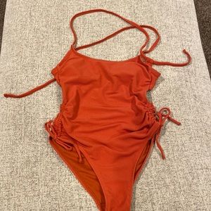 NEVER WORN- Xhileration size M one piece rust color bathing suit
